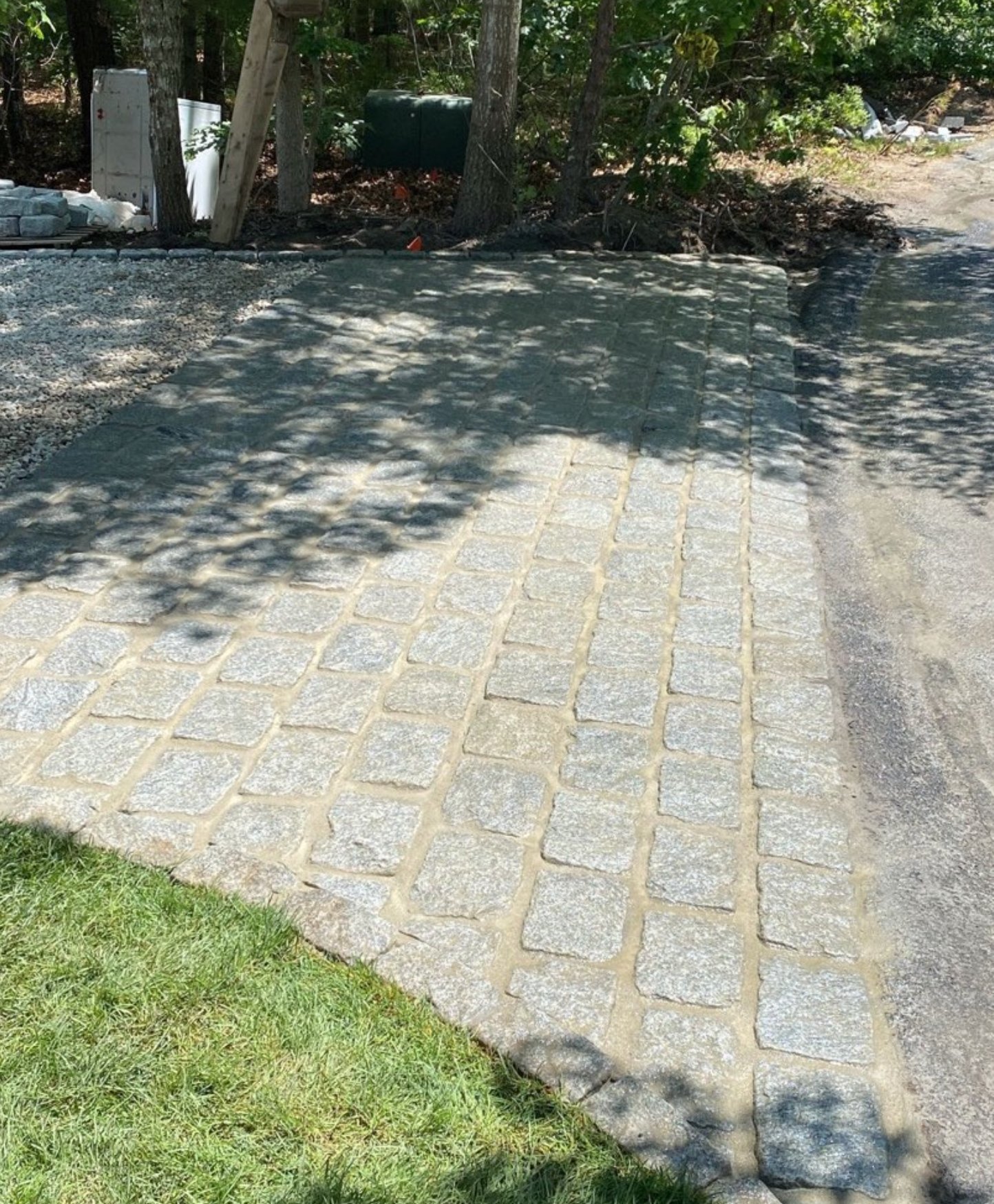 Granite cobble apron laid at the end of a driveway on Cape Cod