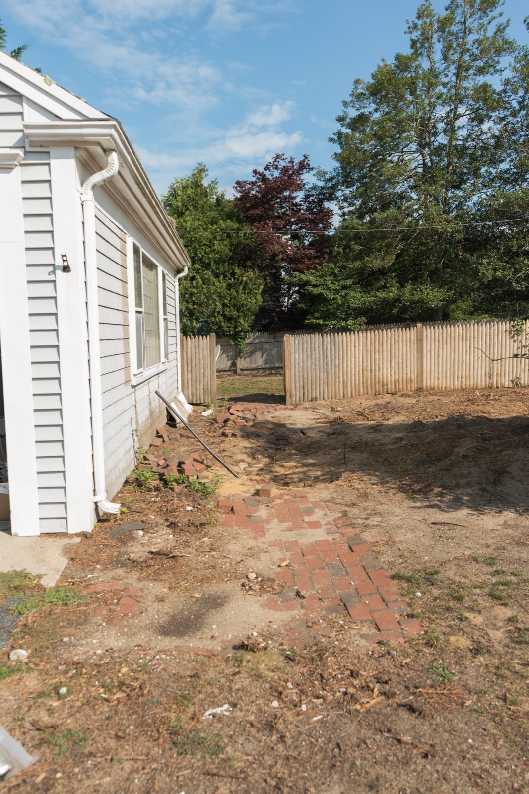 Cleared and graded ground beside a house before planting and hardscape begin