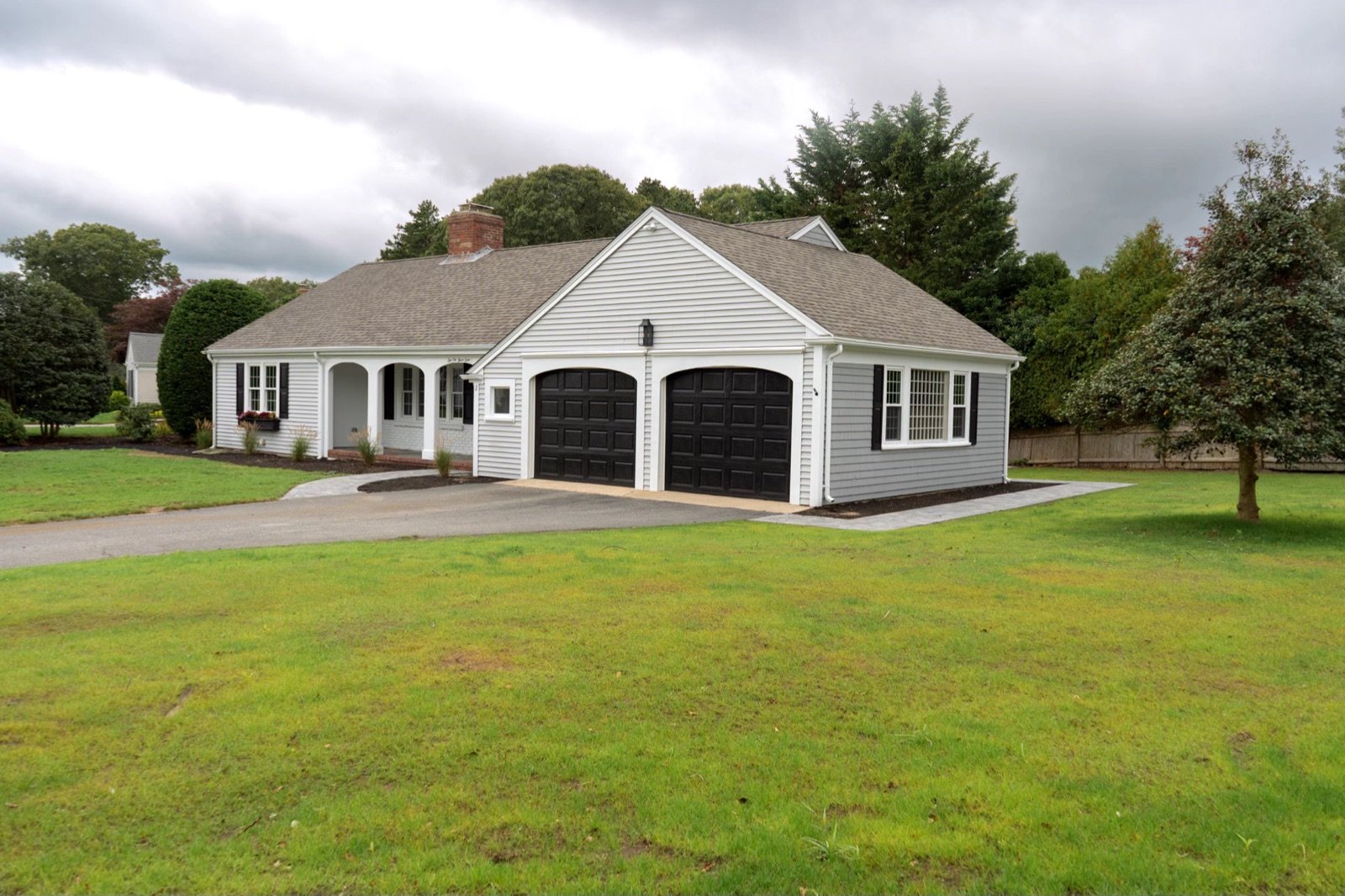 A designed front yard with lawn, driveway edge and foundation planting beds