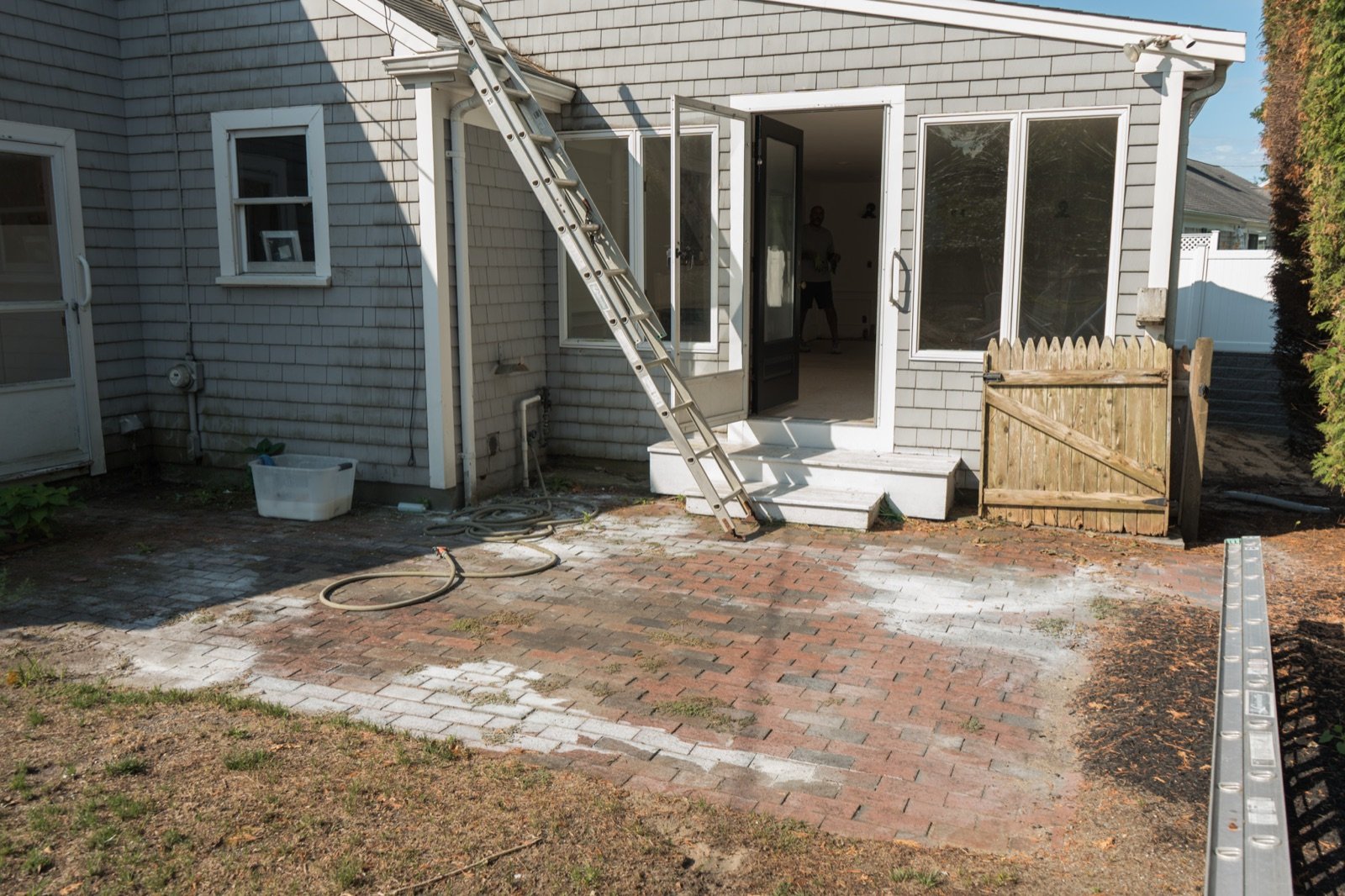 An old stained patio surface at the back of a house before it is taken up and replaced