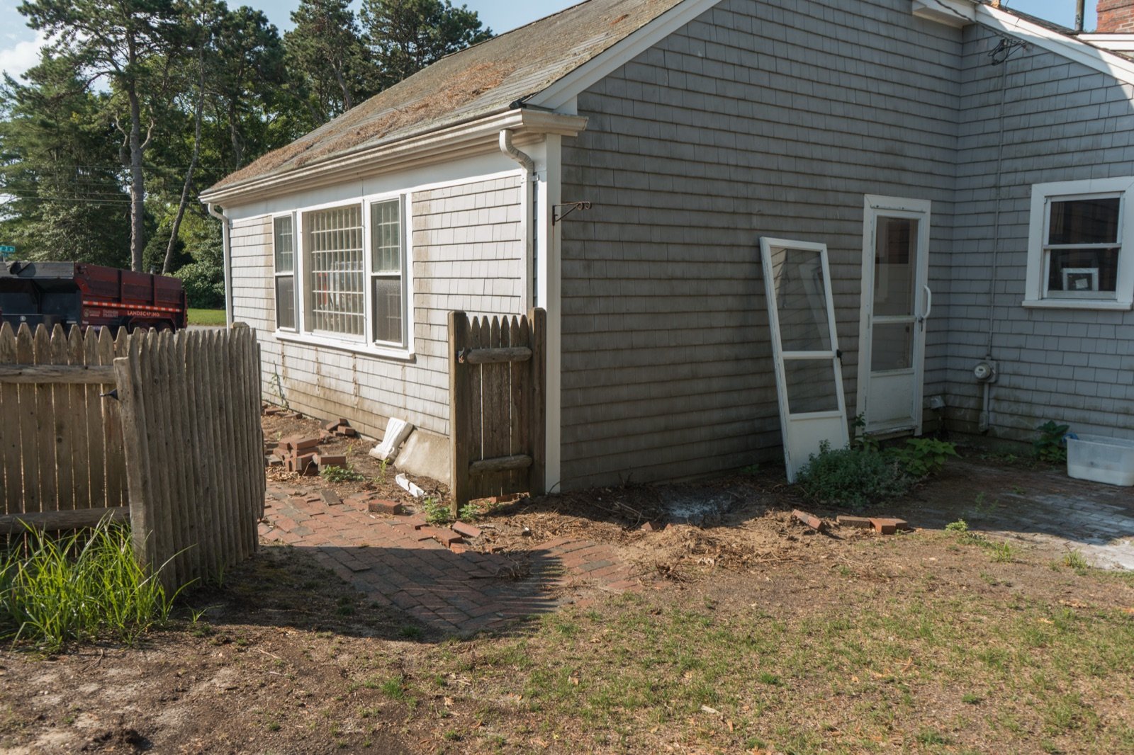 Bare ground at the back of a house being read for drainage before a patio is designed