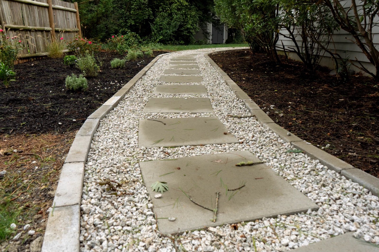 Stone treads set through a white gravel bed that carries roof and surface water away